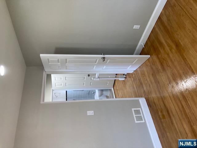 1288 Teaneck Road, Unit 3 Teaneck, NJ 07666 - Photo 12 of 17 a view of a room with wooden floor and white walls