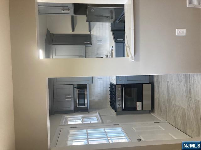 1288 Teaneck Road, Unit 3 Teaneck, NJ 07666 - Photo 2 of 17 a kitchen with stainless steel appliances granite countertop a stove a sink and a microwave