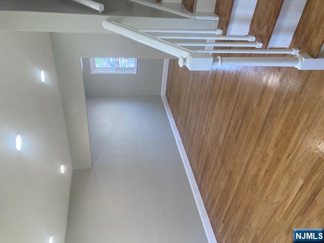 1288 Teaneck Road, Unit 3 Teaneck, NJ 07666 - Photo 4 of 17 a view of an empty room with wooden floor and stairs