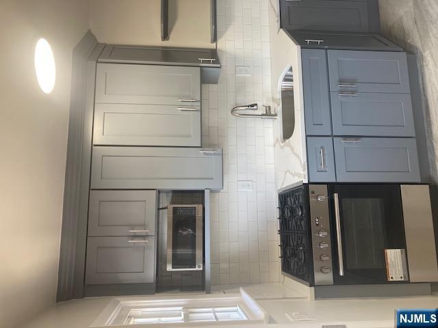1288 Teaneck Road, Unit 3 Teaneck, NJ 07666 - Photo 6 of 17 a kitchen with stainless steel appliances granite countertop white cabinets a stove a sink and dishwasher