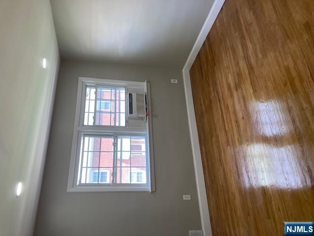 1288 Teaneck Road, Unit 3 Teaneck, NJ 07666 - Photo 10 of 17 a view of an empty room with wooden floor and a window