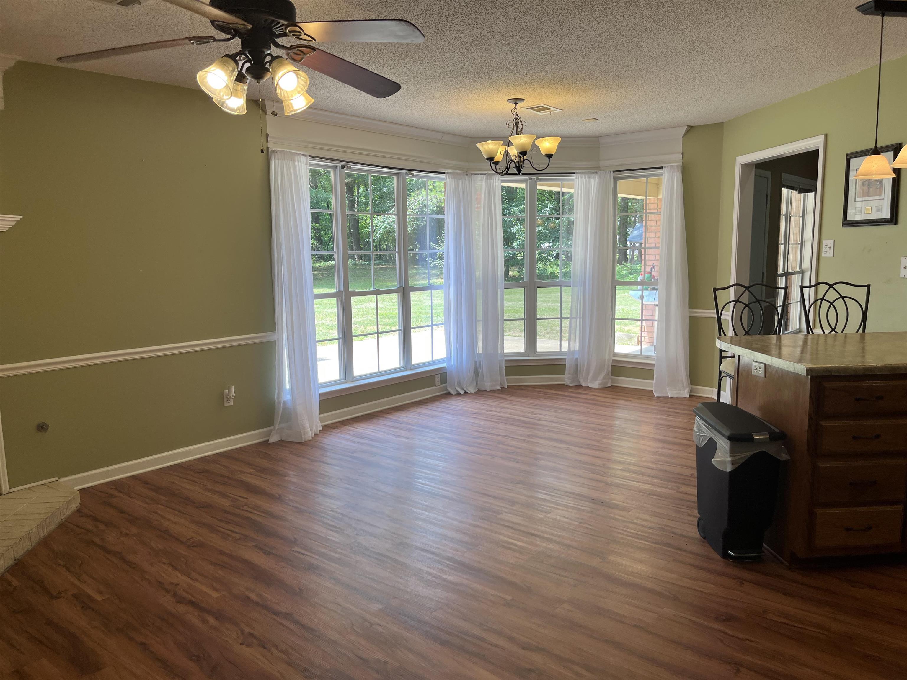 8611 Deadfall Road Millington, TN 38053 - Photo 7 of 25 a view of an empty room with wooden floor and a window