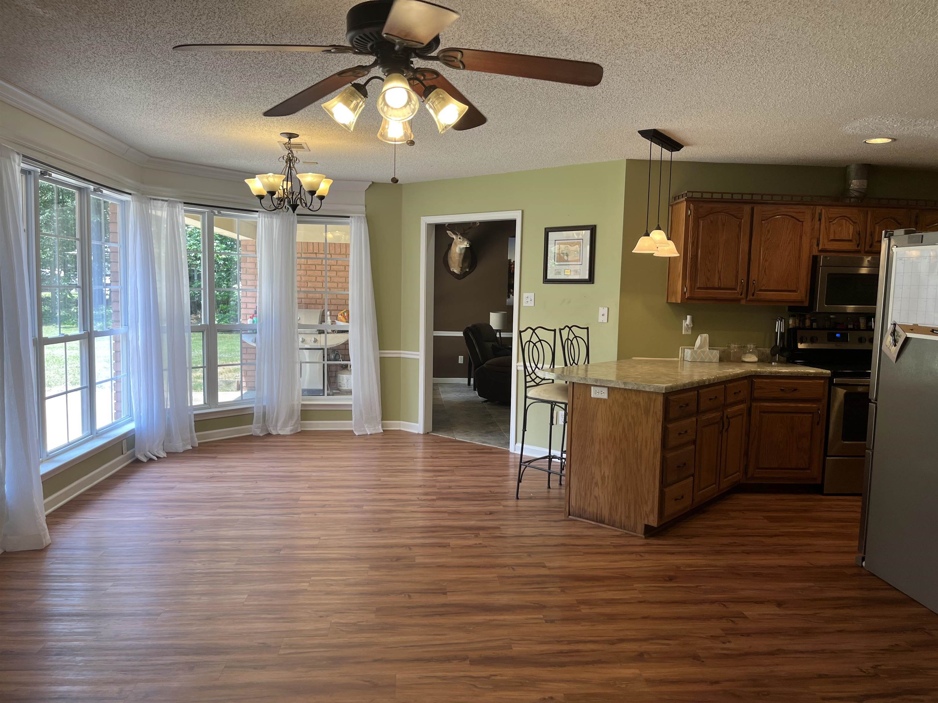 8611 Deadfall Road Millington, TN 38053 - Photo 8 of 25 a kitchen with stainless steel appliances kitchen island granite countertop a refrigerator a stove top oven a sink and dishwasher with wooden floor