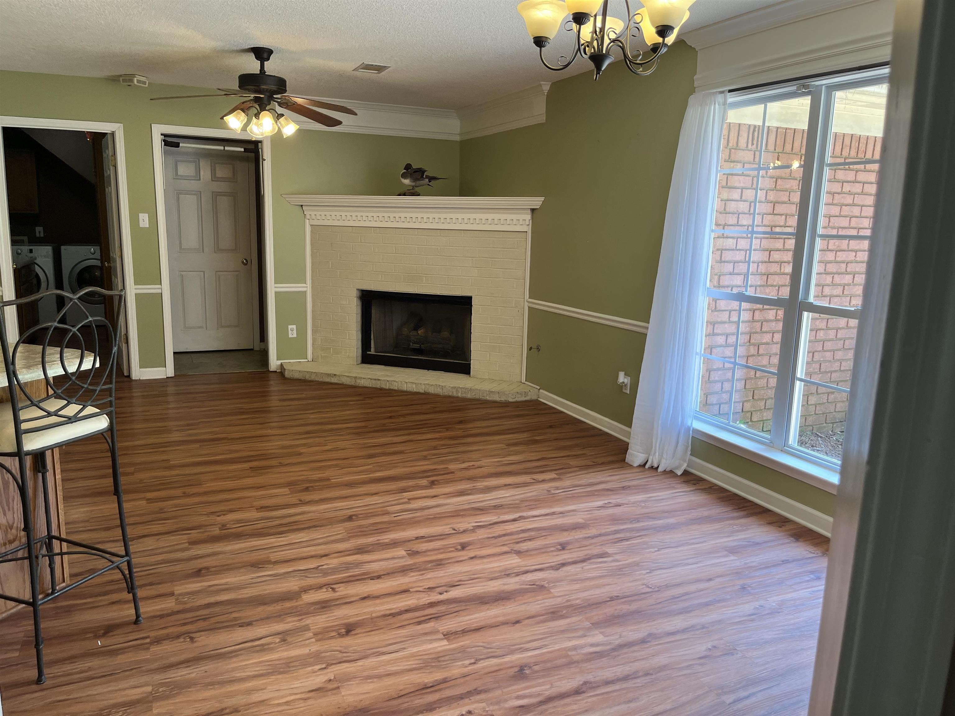 8611 Deadfall Road Millington, TN 38053 - Photo 9 of 25 a view of a livingroom with wooden floor a fireplace and window
