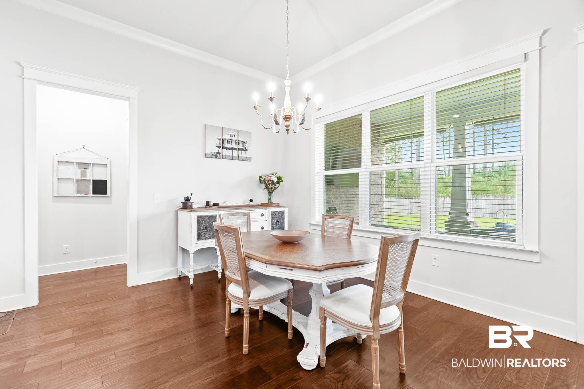 12785 Warbler Street Daphne, AL 36527 - Photo 25 of 53 Dining space featuring dark wood-type flooring, ornamental molding, and a chandelier