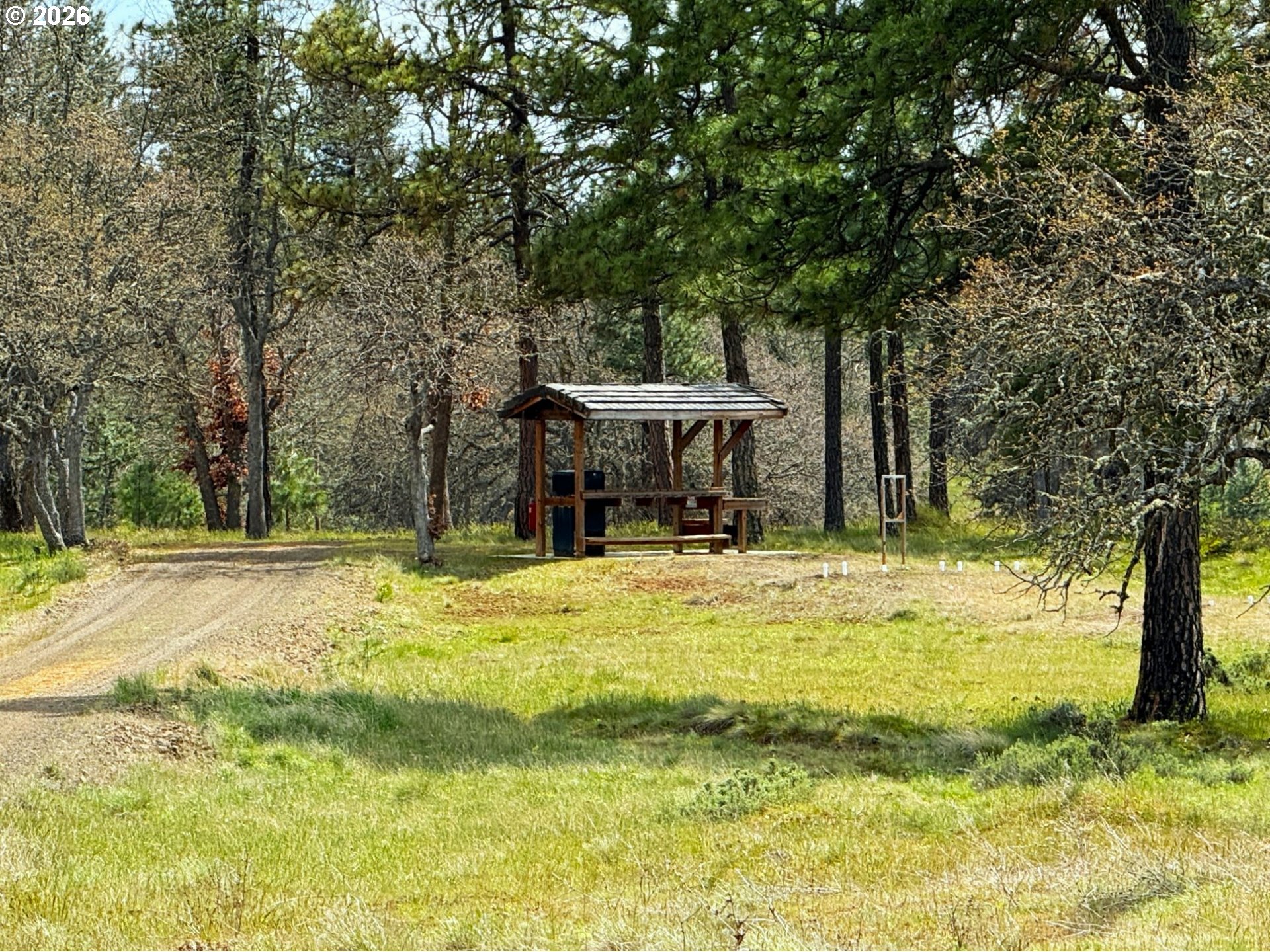 287 Munson Prairie Road Goldendale, WA 98620 - Photo 16 of 48 a backyard of a house with a fountain and large trees
