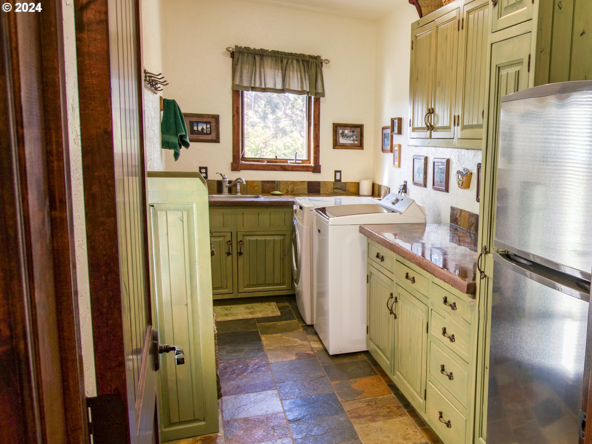 287 Munson Prairie Road Goldendale, WA 98620 - Photo 33 of 48 a room with a refrigerator a washer and dryer