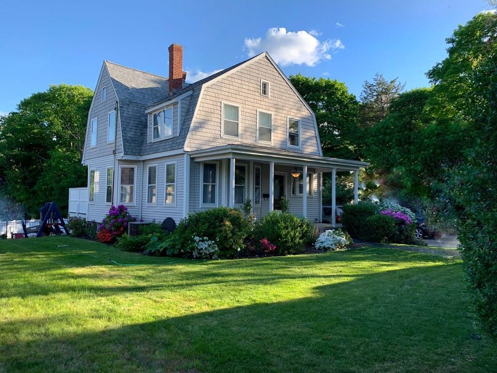 a front view of house with yard and green space