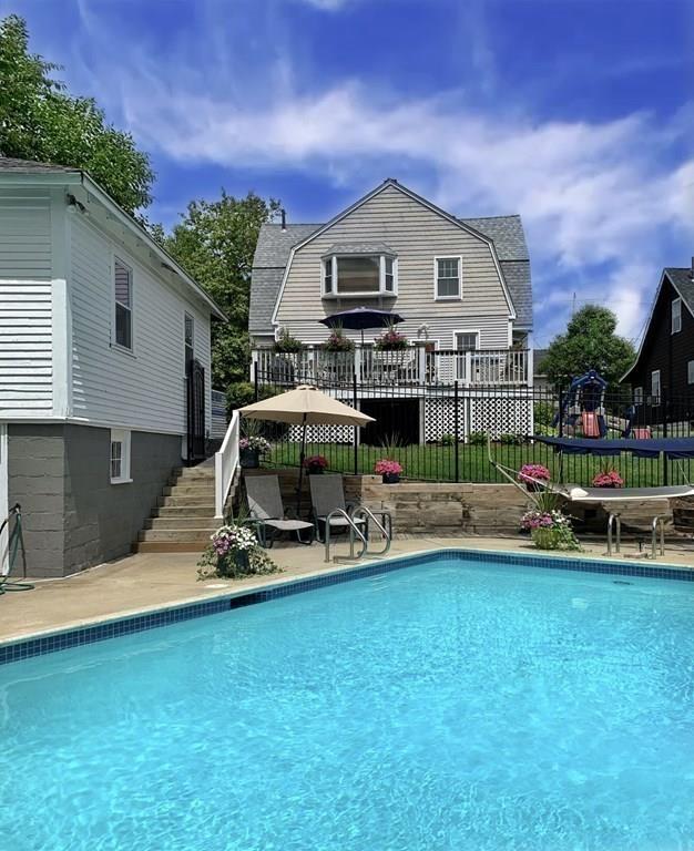 89 Spring Street Stoneham, MA 02180 - Photo 23 of 29 a view of a house with a patio and a yard