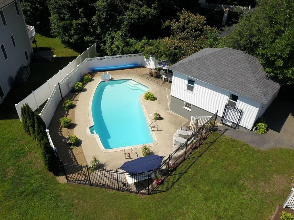 89 Spring Street Stoneham, MA 02180 - Photo 24 of 29 an aerial view of a house with a swimming pool patio and outdoor seating