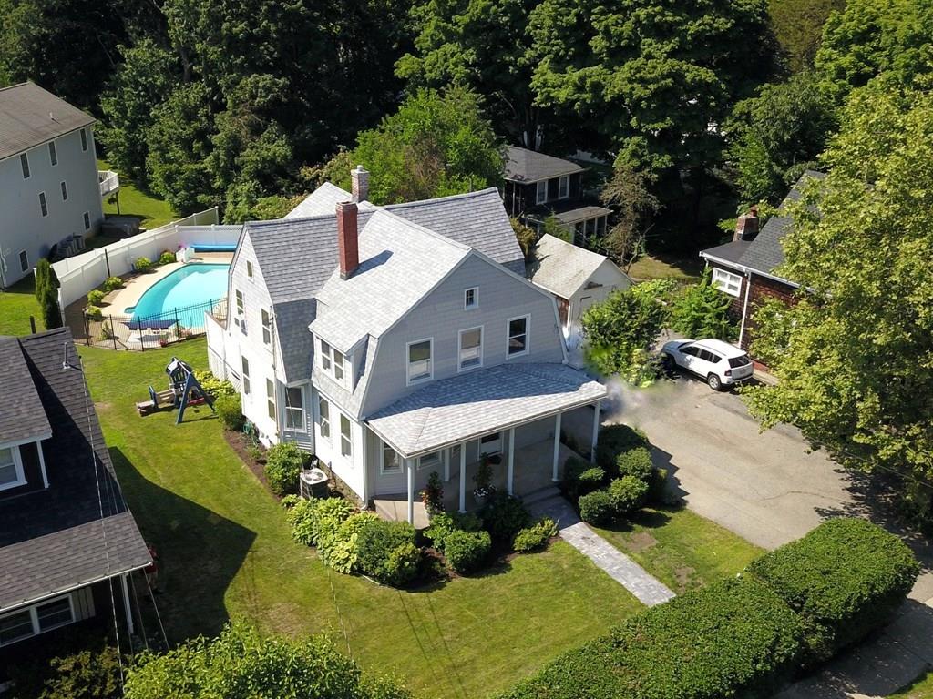 89 Spring Street Stoneham, MA 02180 - Photo 27 of 29 an aerial view of a house with a big yard and large trees