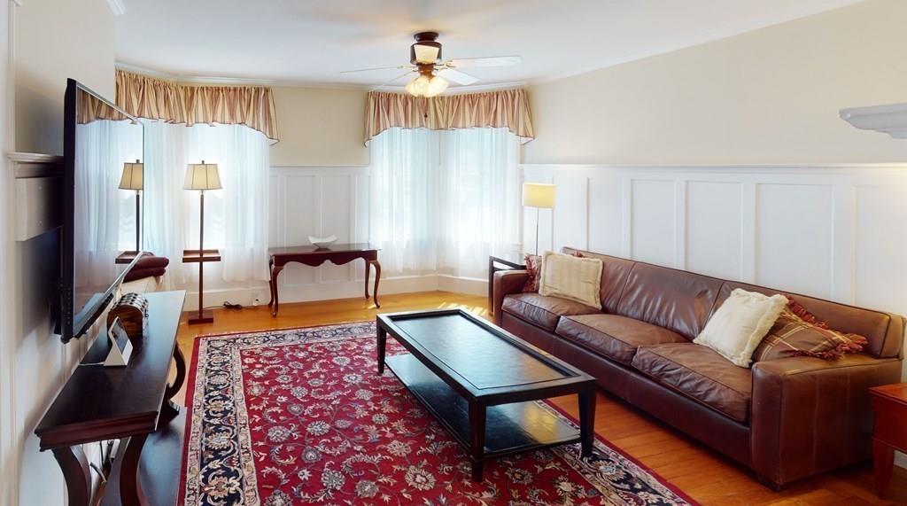 89 Spring Street Stoneham, MA 02180 - Photo 4 of 29 a living room with furniture and a chandelier