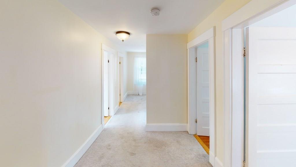 89 Spring Street Stoneham, MA 02180 - Photo 10 of 29 a view of a hallway with wooden floor