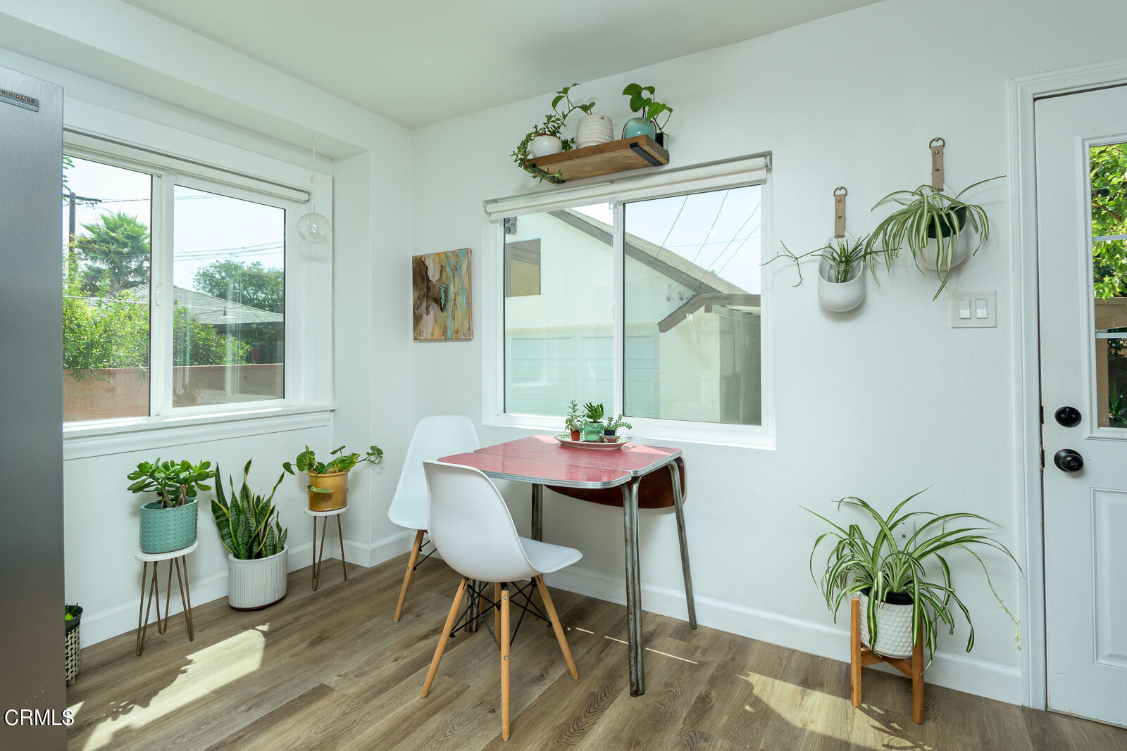 6540 Northside Drive Los Angeles, CA 90022 - Photo 17 of 54 a dining room with furniture potted plants and wooden floor