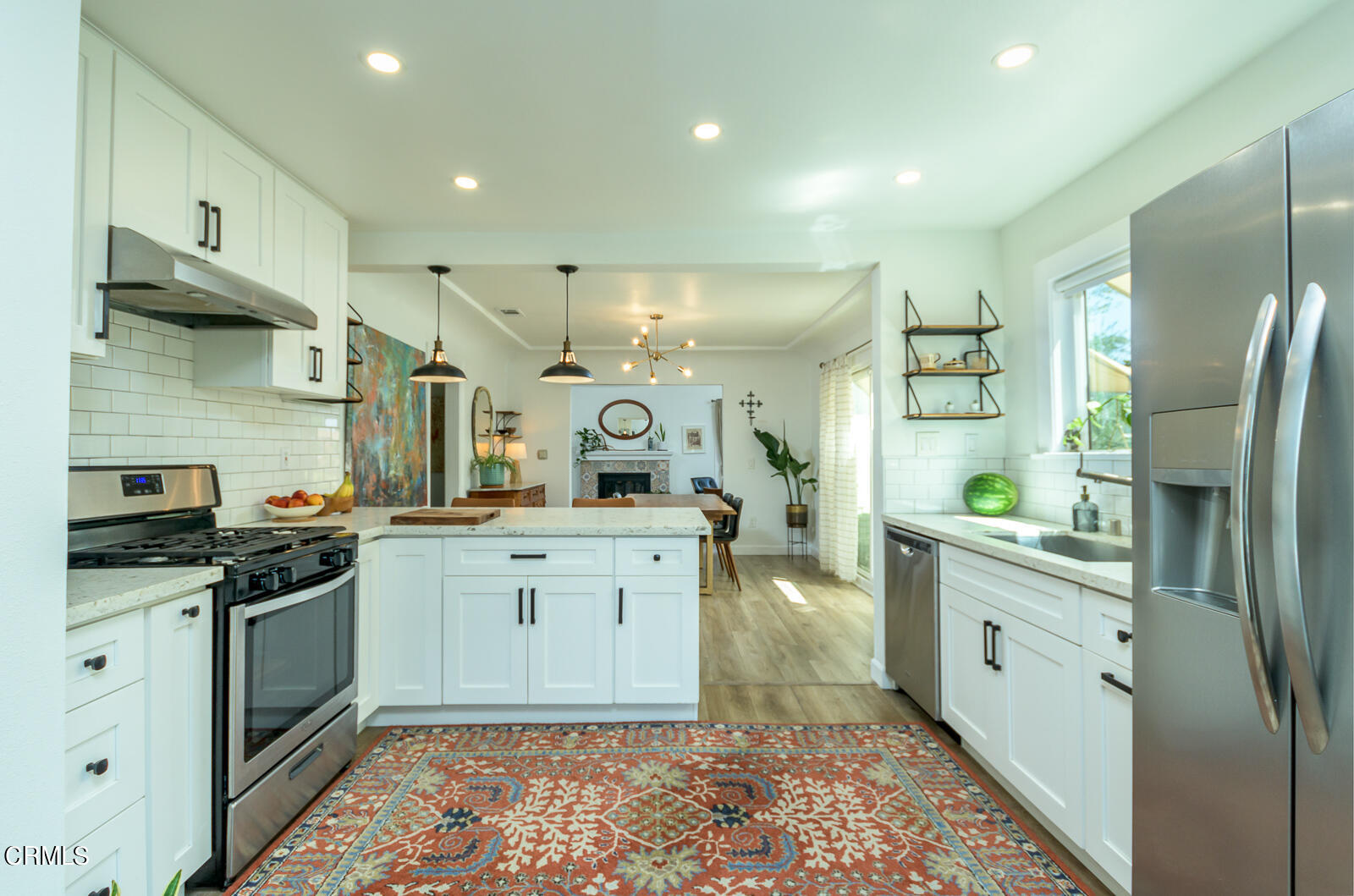 6540 Northside Drive Los Angeles, CA 90022 - Photo 19 of 54 a kitchen with stainless steel appliances granite countertop a sink a stove a refrigerator and cabinets