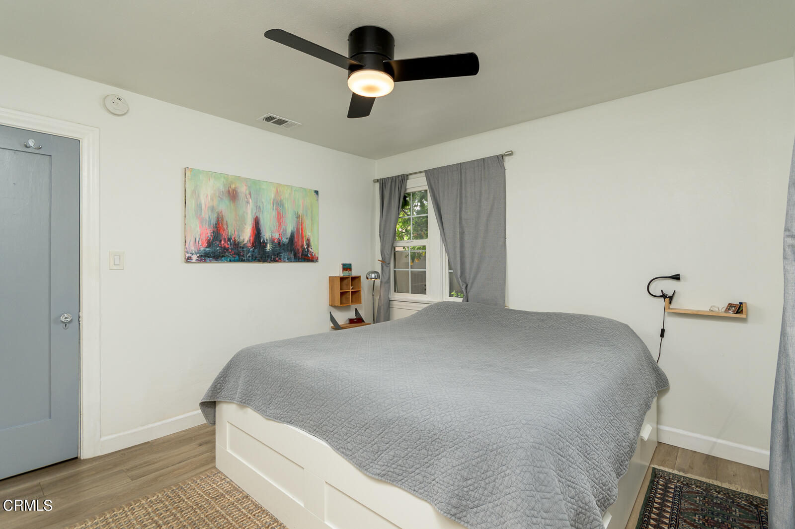 6540 Northside Drive Los Angeles, CA 90022 - Photo 23 of 54 a bedroom with a bed and a painting on the wall