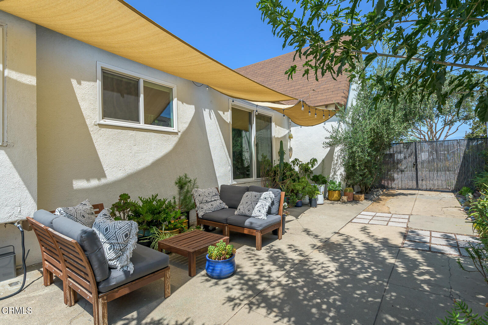 6540 Northside Drive Los Angeles, CA 90022 - Photo 36 of 54 a view of a patio with couches table and chairs and potted plants