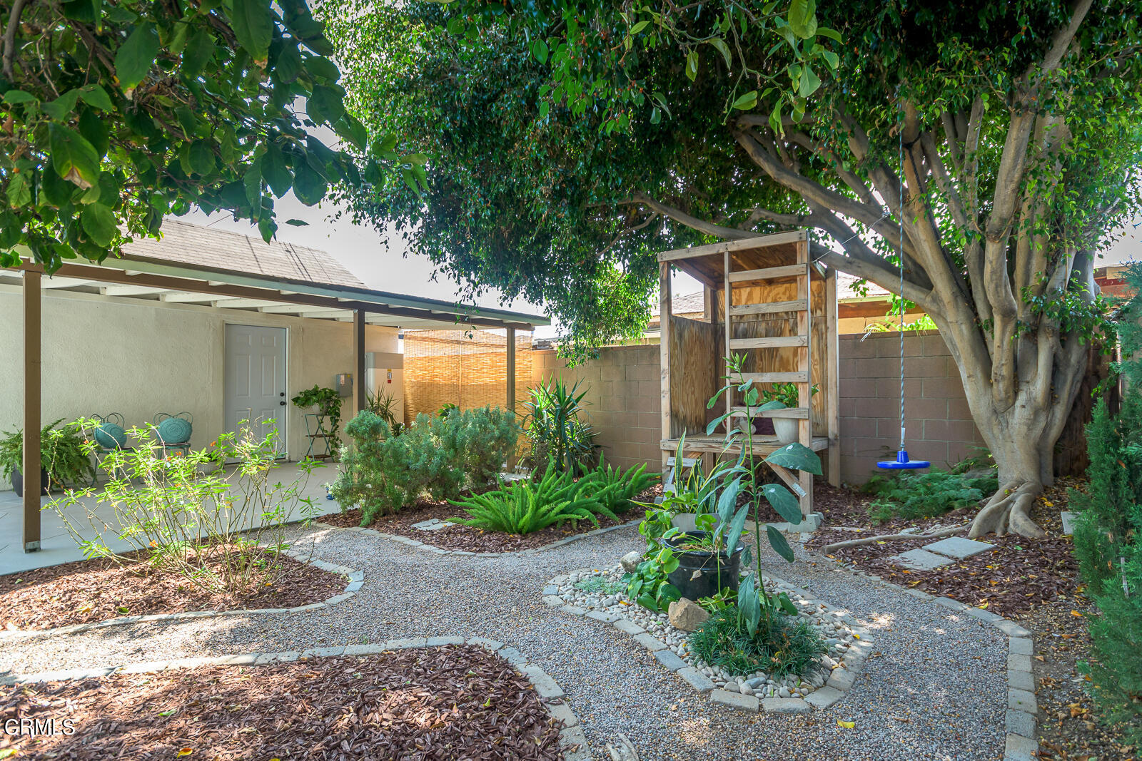 6540 Northside Drive Los Angeles, CA 90022 - Photo 41 of 54 a backyard of a house with plants and large tree