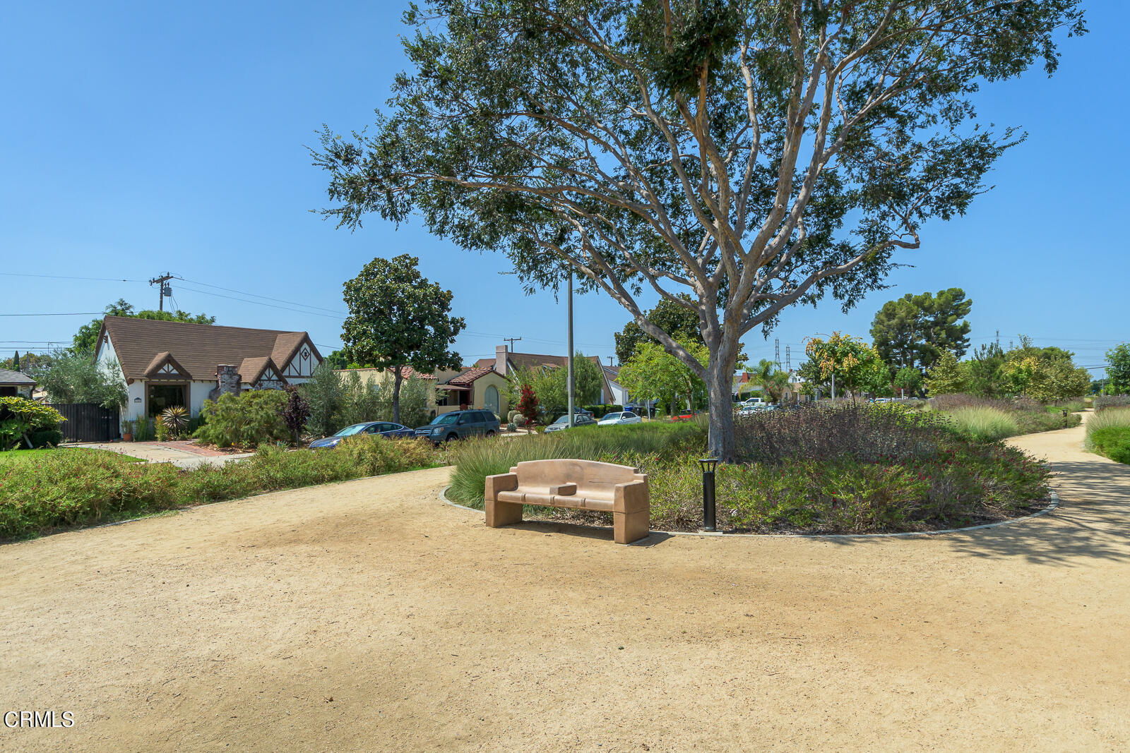 6540 Northside Drive Los Angeles, CA 90022 - Photo 44 of 54 a front view of a house with a yard and a large tree
