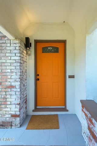 a living room with furniture a fireplace and a floor to ceiling window