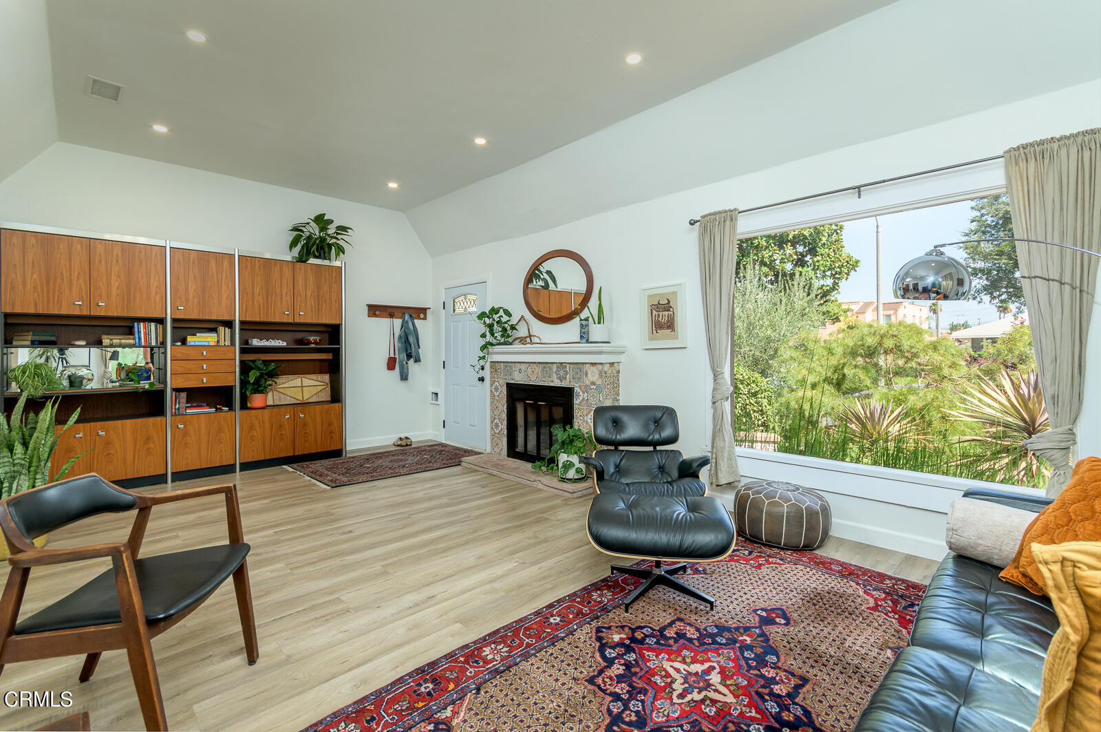 6540 Northside Drive Los Angeles, CA 90022 - Photo 7 of 54 a living room with furniture a fireplace and a floor to ceiling window
