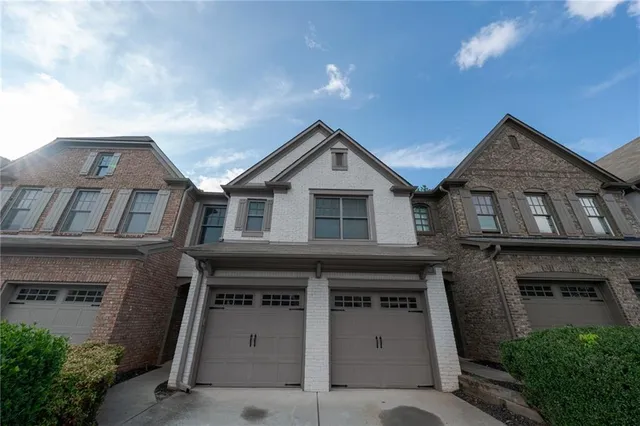 a front view of a house with garage