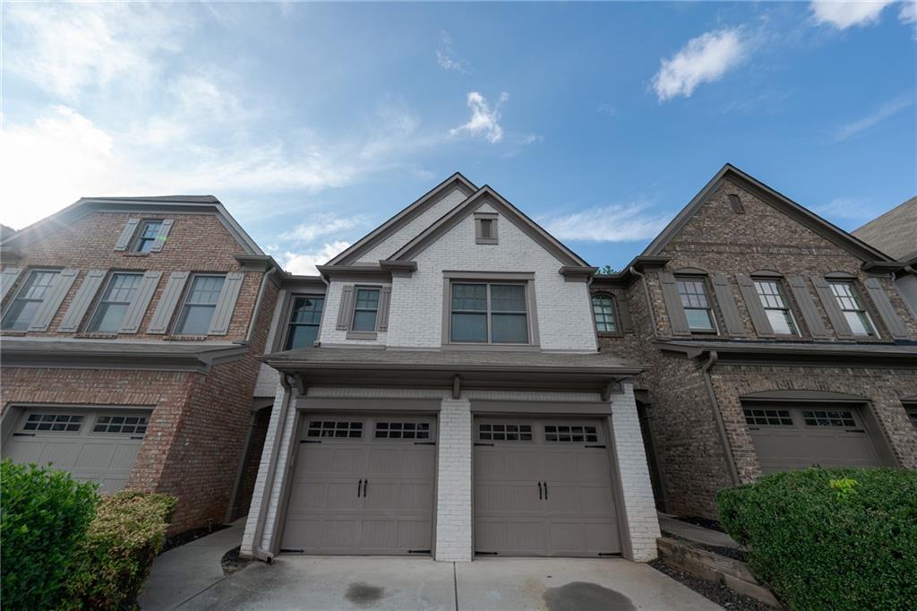 a front view of a house with garage