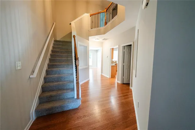 a view of a hallway with wooden floor and entryway