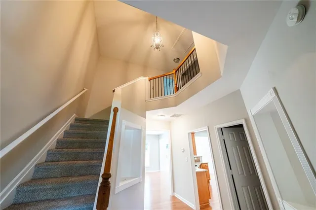 a view of entryway and hall with wooden floor