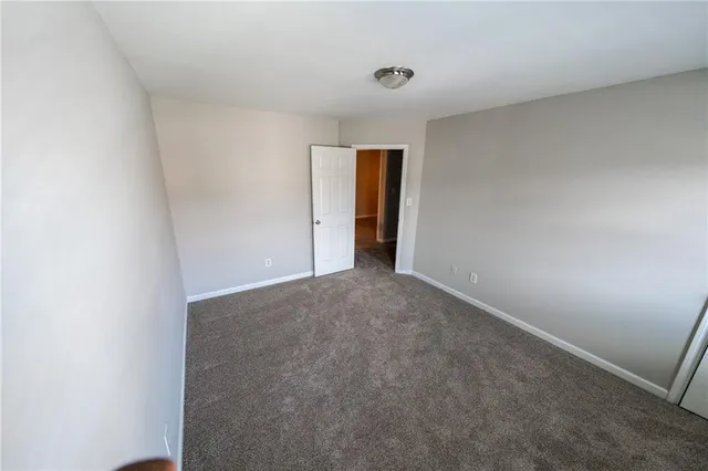 a view of an empty room and a window