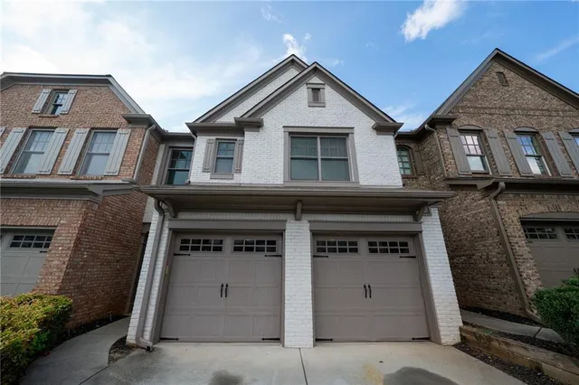 a view of a brick house with large windows
