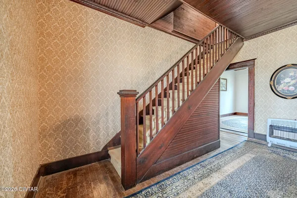 a view of a livingroom with hardwood floor and a ceiling fan