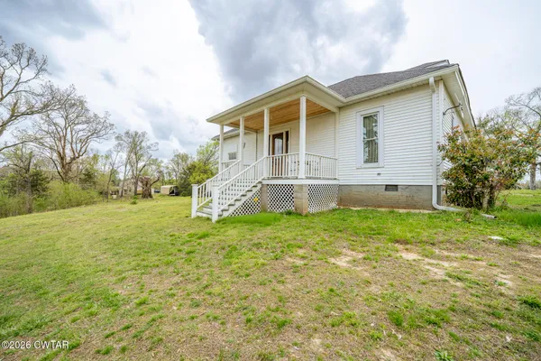 a front view of a house with garden and porch