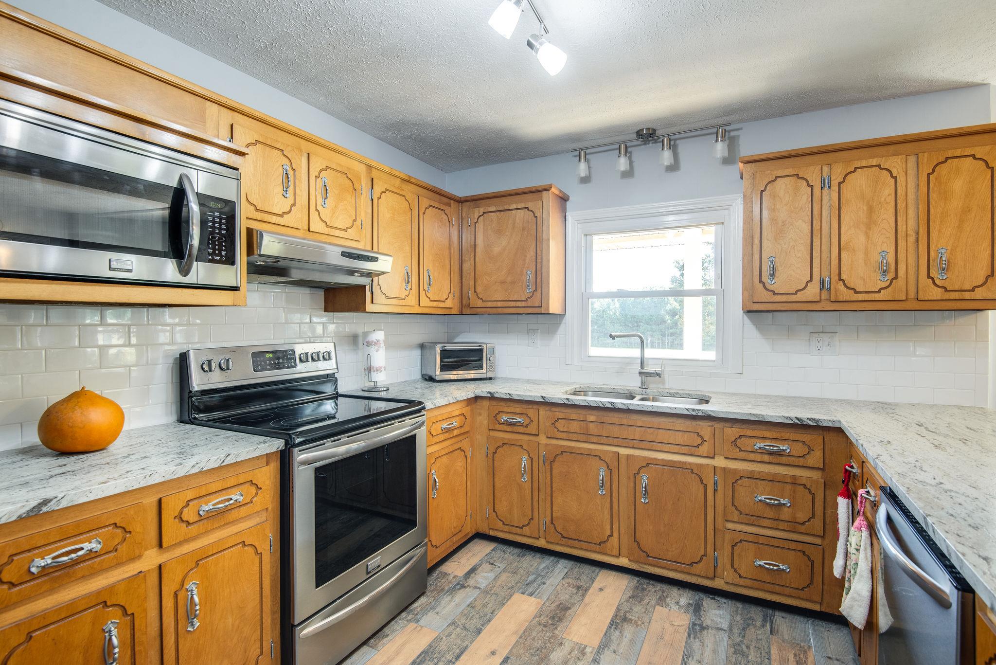 1544 Old Columbia Road Dickson, TN 37055 - Photo 9 of 30 Kitchen has new stainless appliances (stove never even used) and new LEATHER GRANITE counter tops installed in May of 2018! 2 pantries.