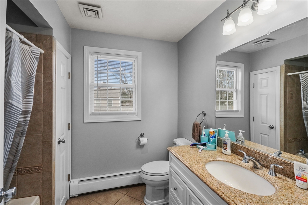 79 Coral Road North Attleboro, MA 02760 - Photo 12 of 14 a bathroom with a granite countertop toilet a sink and a mirror