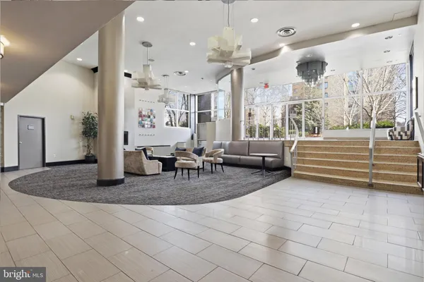 a living room with furniture and a chandelier