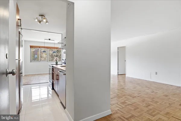 a view of a hallway to a livingroom with furniture