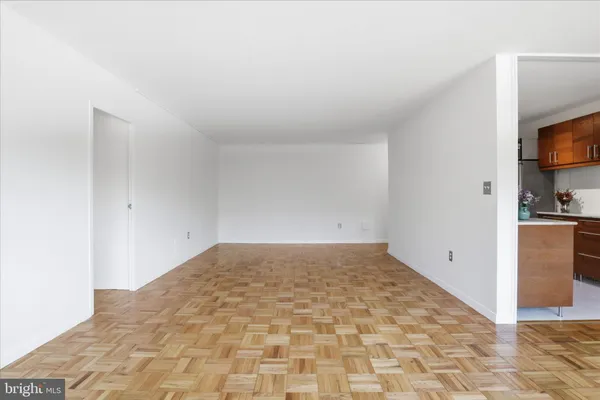 a view of empty room with wooden floor