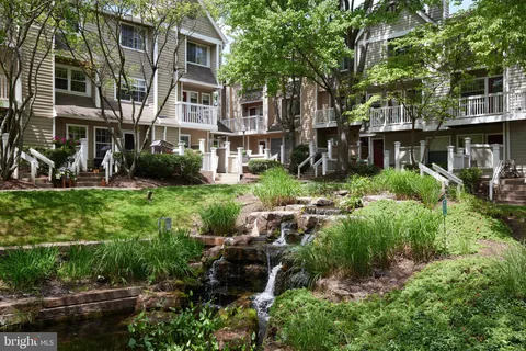 a view of backyard with plants and outdoor seating