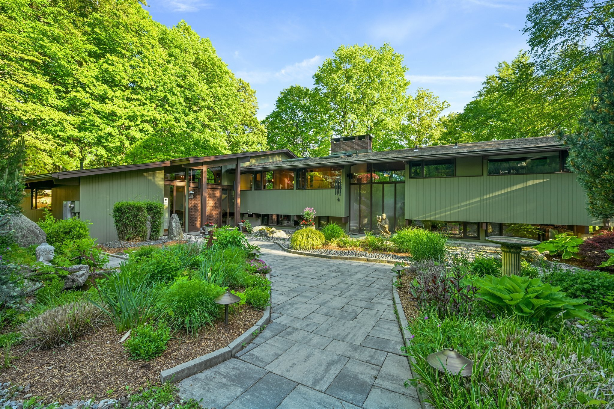 25 Ketcham Road Ridgefield, CT 06877 - Photo 1 of 1 a view of a backyard with plants and a garden