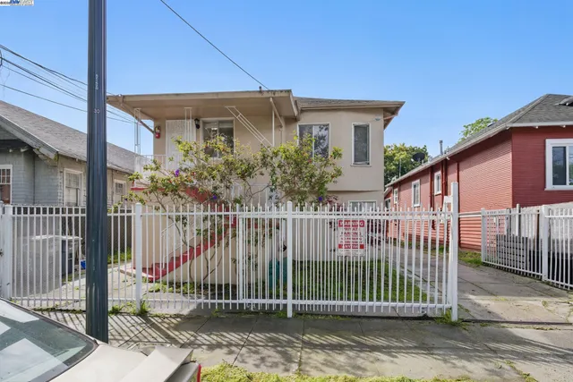 a view of a house with wooden fence