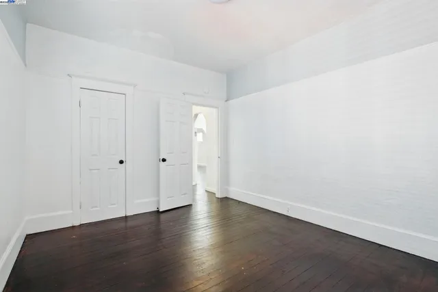an empty room with wooden floor