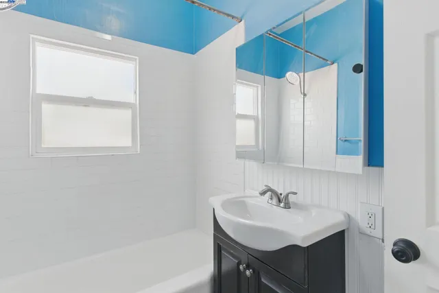 a bathroom with a sink a mirror and a bathtub