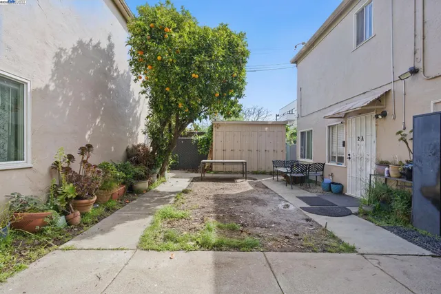 a view of a house with backyard and sitting area