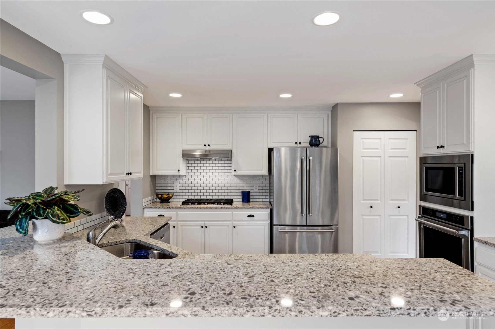 3108 191st Street Southeast Bothell, WA 98012 - Photo 4 of 31 a kitchen with stainless steel appliances kitchen island granite countertop a refrigerator and a sink