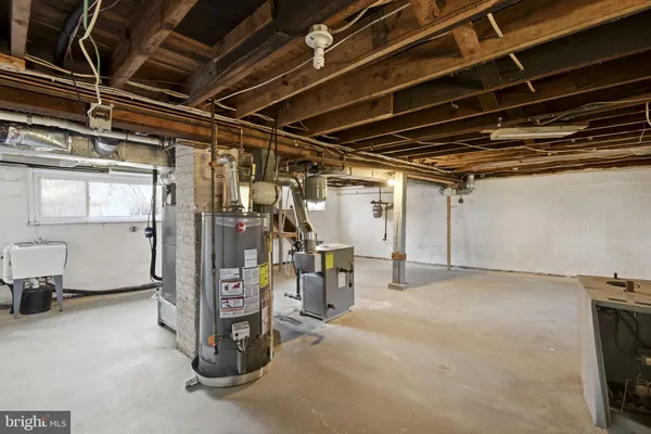 a view of water heater room with refrigerator