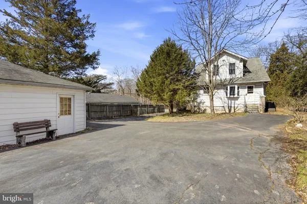 a view of house with yard and trees in the background
