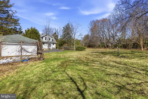 a view of a yard with a house in the background