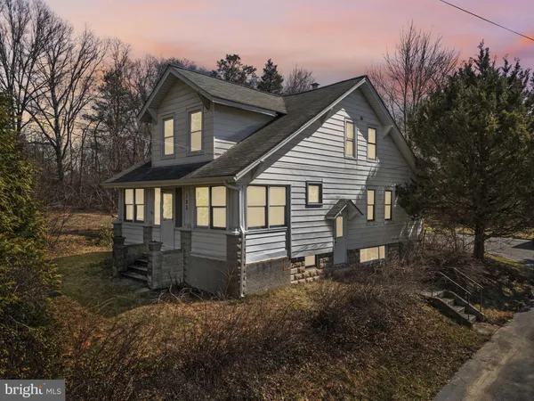 a view of a house with a yard and sitting area