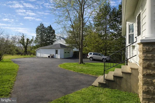 a house with green field in front of it